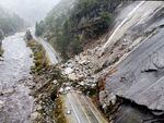 Rocks and vegetation cover Highway 70 following a landslide in the Dixie Fire zone on Oct. 24, 2021, in Plumas County, Calif.
