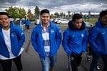 Hector Capetillo (second from left) and Yobeli Manzo walk through the parking lot of Summit High School in Bend, Oregon.