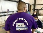 Klamath Health Partnership Clinical Information Specialist Diego Aguirre shows off the organization's mobile COVID testing shirt.
