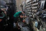 A technician controls an electric switch board connecting homes to privately-owned electricity generators in a suburb of Baghdad on June 30, 2021 as the national electric grid experienced outages amidst a severe heat wave.
