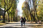 Hanna Korchevska and her son Ulysses walk through a park in Lviv. Sharing the single room between the four family members means they spend a lot of time out walking to avoid the cramped space.