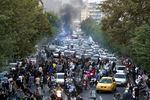 In this Wednesday, Sept. 21, 2022, photo, protesters chant slogans during a protest over the death of a woman who was detained by the morality police, in downtown Tehran, Iran.