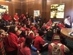 Activists with Oregon Rising Tide sit in at Gov. Kate Brown's office Thursday, Nov. 21, 2019, in Salem, Ore., demanding she come out against the Jordan Cove LNG project on the coast.