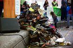 A pile of shoes labeled with the name of someone lost to alcohol or drug addiction at a rally for recovery on Sept. 30, 2017.