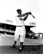 Jackie Robinson, infielder for the Brooklyn Dodgers, swings his bat in this action pose at Ebbett's Field in Brooklyn, N.Y., on May 9, 1951.