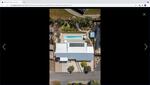 A view from above of a house with a swimming pool.