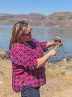 Casie Davidson, a scientist at Pacific Northwest National Laboratory, points out how basalt rocks are layered on top of each other. The rocks formed millions of years ago after volcanic eruptions and could now help store carbon dioxide.