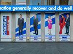 Among the stars being questioned under oath for Dominion Voting Systems' defamation suit against Fox News are Tucker Carlson, Sean Hannity and Maria Bartiromo. Banners bearing their images hang from Fox Corp headquarters in New York City, first, second and fourth from left, respectively.