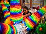 A woman prepares traditional Mexican piñatas for sale at a market in Acolman, Mexico state, in 2017.