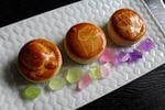Handcrafted by Renaud, colorful sea glass confections accompany manju, buttery rolls with a bean jam paste filling. The tops are glazed with a little dark soy and white wine, offering up a toasty aroma.