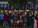 President Biden signs the Infrastructure Investment and Jobs Act, part of Biden's climate plans, in November on the South Lawn at the White House.