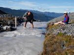Oliver Grah and Liza Kimberly measure the flow of glacier-fed Sholes Creek on Mount Baker