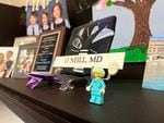 O'Neill displays a Lego minifigure of a female doctor on her desk with family photos of her children in the background.  Her mother-in-law gave her figure as a gift after she graduated from medical school.