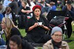 A well-wisher waits in Hyde Park where the State Funeral Service of Britain's Queen Elizabeth II will be shown on a large screen in London.