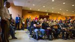 People watch video of testimony on Senate Bill 978 at the Capitol in Salem, Ore., Tuesday, April 2, 2019. An amendment to the bill before the Senate judiciary committee requires safe storage of firearms, allows retailers to refuse some gun sales and more.