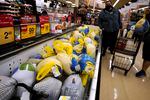 People shop for frozen turkeys for Thanksgiving dinner at a grocery store in Mount Prospect, Ill., Wednesday, Nov. 17, 2021.  First, the good news: There is no shortage of whole turkeys in the U.S. this Thanksgiving. But those turkeys — along with other holiday staples like cranberry sauce and pie filling — could cost more. (AP Photo/Nam Y. Huh)