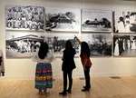 In this photo taken Jan. 2023, U.S. Interior Secretary Deb Haaland (center) looks at archival photos of the Phoenix Boarding School during a visit to Arizona as part of her "Road to Healing" tour.