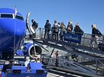 Passengers board a Southwest Airlines airplane at Hollywood Burbank Airport in Burbank, California on October 10, 2021. The airline has continued to cancel or delay hundreds of flights on Monday.