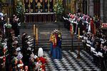 Members of the Royal family and guests sing as the coffin of Queen Elizabeth II, draped in the Royal Standard, lies by the altar.