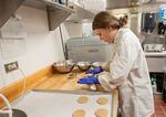 In this photo released by Washington State University, food science graduate student Elizabeth Nalbandian prepares cookie dough containing quinoa flour for baking.