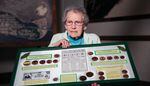 Lifelong North Bend, Oregon, resident Pat Choat Pierce poses with her collection of the city's myrtlewood money. Pierce is widely regarded as the foremost expert on North Bend's wooden currency.