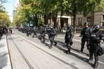 Police in riot gear respond to a protest outside Portland City Hall.