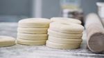 A stack of brioche doughnut dough awaits further proofing, frying and glazing at the Blue Star Donuts kitchen in Northwest Portland.