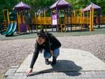 Erica Lafferty, whose mother Dawn Lafferty Hochsprung was killed during the Sandy Hook school shooting in 2012, points out some of the names of friends and family at the playground honoring her mother in Watertown, Conn., Wednesday, May 25, 2022.
