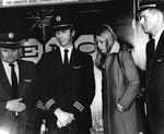 Three pilots and a flight attendant speak at a press conference.
