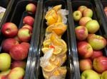 Apples and orange slices rest in trays for student lunch at Albert D. Lawton Intermediate School in Essex Junction, Vt., on June 9, 2022.