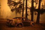 FILE - A burned out car in Gates, Ore., following devastating statewide fires in September 2020.