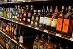 In this file photo, bottles of tequila line the shelves in a liquor store. “Alcohol is the great dirty little secret of the pandemic,” says Dr. Robin Henderson, the chief executive for behavioral health for the Providence health system in Oregon.