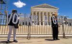 Demonstrators hold up large cut-out letters spelling "VOTING RIGHTS" at a 2021 rally outside the U.S. Supreme Court in Washington, D.C.