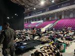 Ukrainians sleep on cots inside of a pop-up refugee center in Poland where Portland doctor Joe Howton helped triage patients and delivered medical supplies.