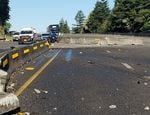 A blown tire on a truck carrying a crane Monday, June 27, 2022, led to a crash that closed a long section of I-84 between Hood River and Troutdale, according to Oregon State Police. The truck later caught fire but the driver reportedly escaped with minor injuries.
