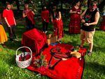 Participants brought the red dresses to a blanket and chair setting, intended to honor MMIW/MMIG victims on Wednesday May 4, 2022. A basket of tobacco-filled pouches and a rawhided drum also complemented the arrangement.