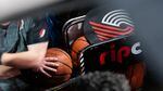 A member of the Trail Blazers promotion team prepares to wheel out a cart of basketballs during a National Basketball Association game between the Portland Trail Blazers and the Toronto Raptors at the Moda Center in Portland, Ore., Wednesday, Nov. 13, 2019. The Raptors won 114-106.