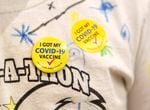 Wesley DeCastro wears a button and sticker after his vaccination Nov. 10, 2021, in Happy Valley, Ore. 