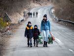 A woman and two children leave Ukraine after crossing the Slovak-Ukrainian border in February.