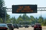 A file photo of a sign on U.S. Highway 26 outside of Portland encouraging people to get their COVID-19 vaccination, taken June 28, 2021.