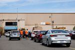 Vehicles queue at the Amazon delivery station in northwest Portland, Ore., Friday, July 12, 2019.