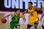 Oregon guard Chris Duarte (5) drives on Iowa forward Keegan Murray (15) during the second half of a men's college basketball game in the second round of the NCAA tournament at Bankers Life Fieldhouse in Indianapolis, Monday, March 22, 2021.