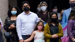 Supporters of transgender rights gather in Texas, all wearing masks to cover their mouths and noses.