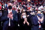 Portland Trail Blazers interim general manager Joe Cronin, left, team owner Jody Allen, center, and president of business operations Dewayne Hankins, right, all wearing masks, clap during player introductions before an NBA basketball game against the Oklahoma City Thunder in Portland, Ore., Friday, Feb. 4, 2022.
