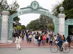 Students make their way through the Sather Gate near Sproul Plaza on the University of California, Berkeley, campus on March 29 in Berkeley, Calif.