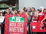 The Rose City Riveters erupt into cheers as the Portland Thorns emerge from the Portland International Airport Sunday, Oct. 15, 2017.