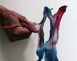 Colors dance when Daniela Molnar drops homemade paint into water on paper.
