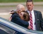 Oregon Gov. Kate Brown welcomes President Joe Biden with a big hug after he arrived at Portland’s airport, April 21, 2022. 