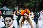 A woman dressed as Mexico's iconic "Catrina" takes part in the Grand Procession of the Catrinas, part of upcoming Day of the Dead celebrations in Mexico City on Sunday, Oct. 23, 2022.