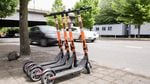 Commuters pass by a row of parked SPIN electric scooters on SW Naito Parkway in downtown Portland, Ore., on Friday, May 17, 2019.